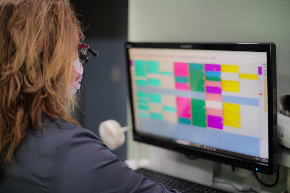 sutton dentistry team member scheduling an appointment