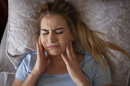 woman experiencing TMJ pain in ocala fl