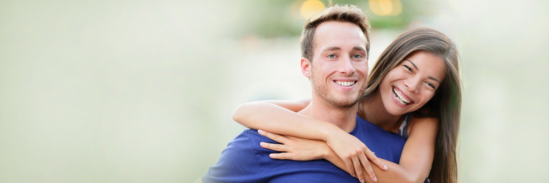 Smiling couple with healthy bright smiles featured in Sutton Dentistry blog about common dental ques