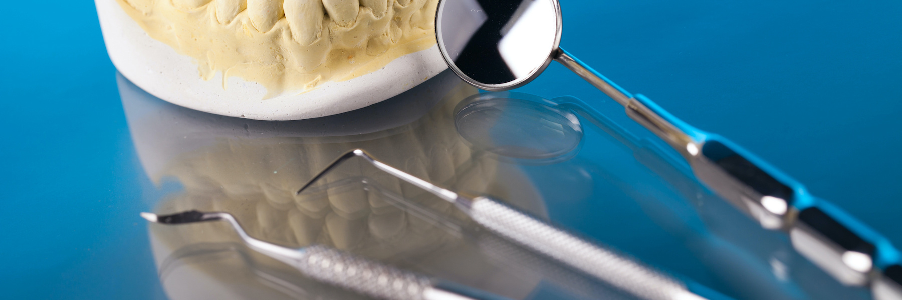 Dental tools and tooth model representing emergency dental care preparation in Ocala, FL