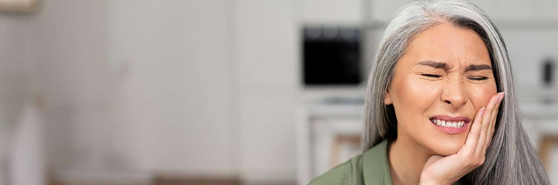 A woman in pain before getting an Emergency Dentistry treatment in Ocala, FL