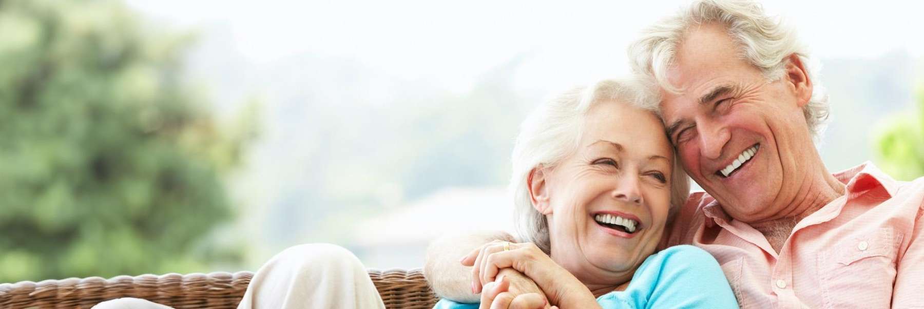an elderly couple smiling together after getting a Full Mouth Restoration in Ocala, FL