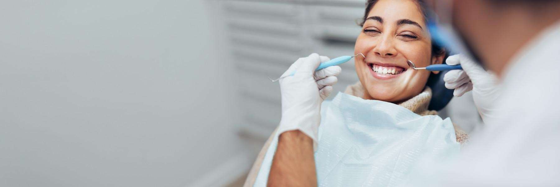 A woman smiling while getting a Root Canal Treatment in Ocala, FL