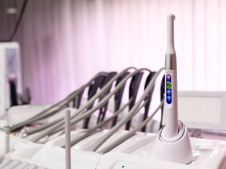 Modern dental curing light and treatment tools prepared for advanced restorative procedures at Sutton Dentistry in Ocala, FL.