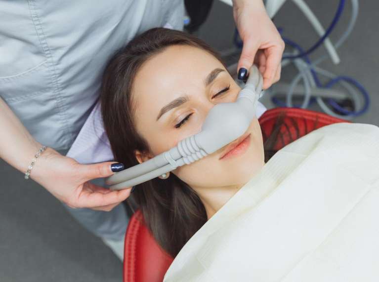 Patient receiving comfortable dental care with nitrous oxide sedation during treatment at Sutton Dentistry in Ocala, FL.